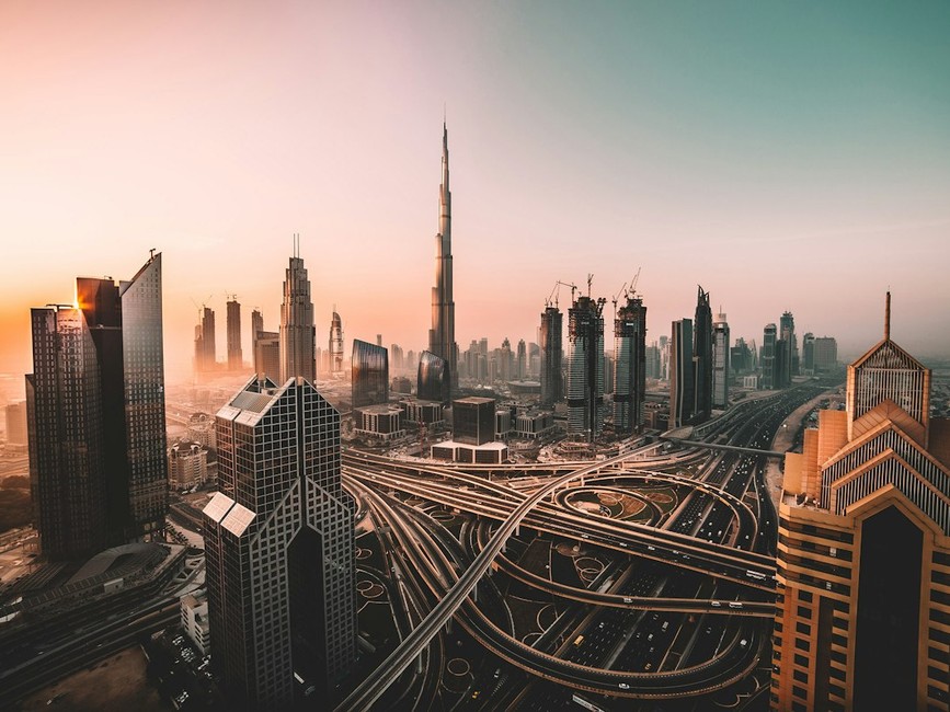 Stunning view of a luxury restaurant overlooking the Dubai skyline against a clear blue sky, capturing modern architecture.